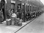 Children waiting for the 'farthing bundles' at the Fern Street settlement, 1934